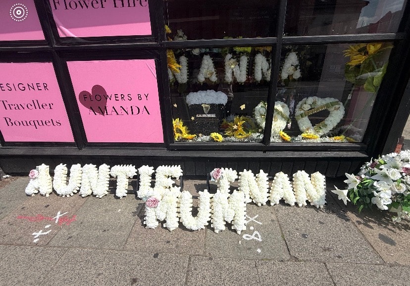 White floral tribute outside flower shop