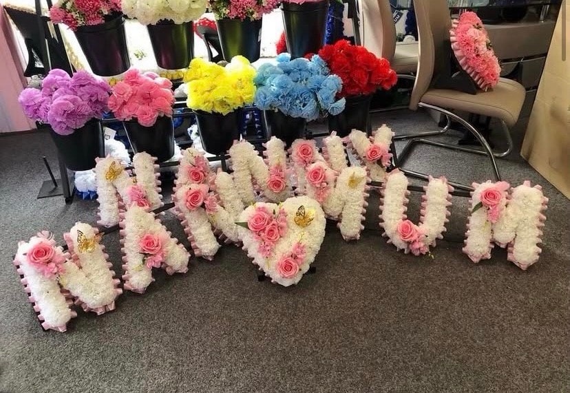 Colourful floral arrangements in black vases